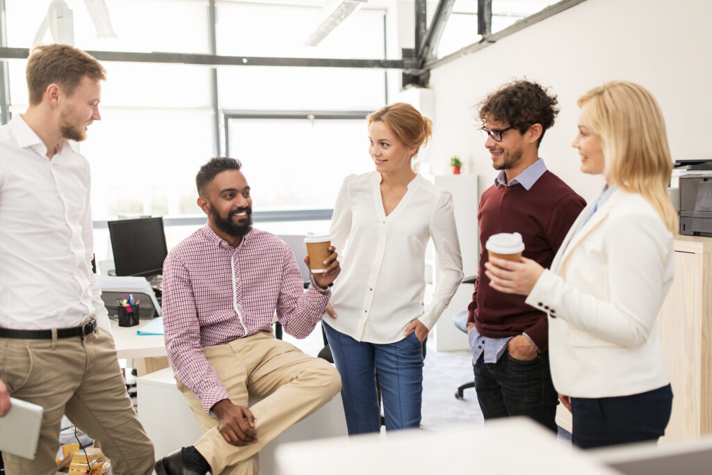 A group of professionals talking in a positive work environment